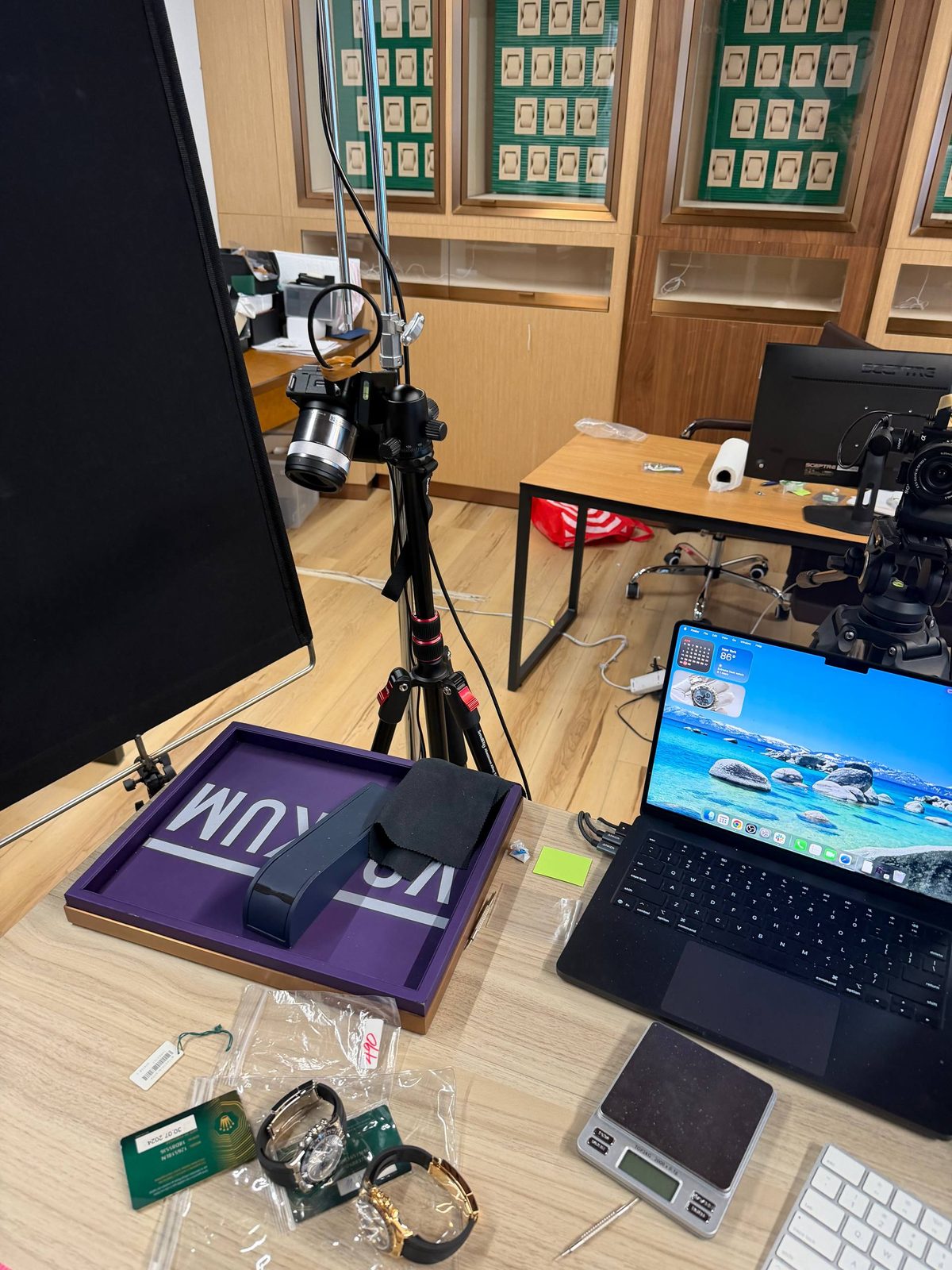 Production desk with camera stand, laptop, purple Vookum tray and two watches